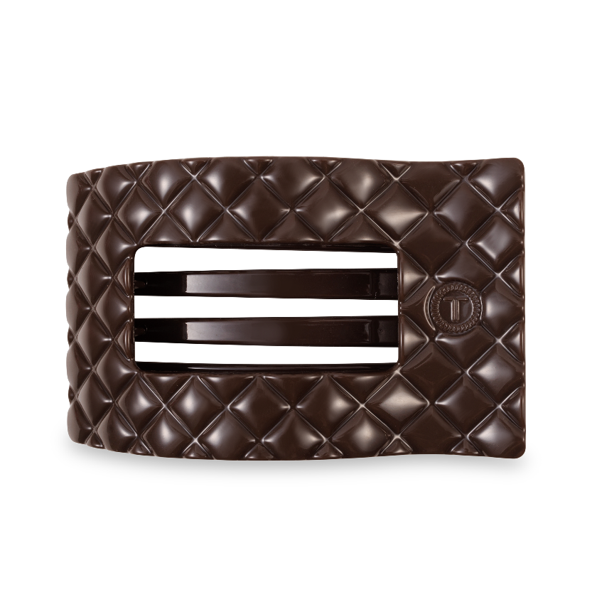 Brown quilted clutch bag with a silver clasp on a white background