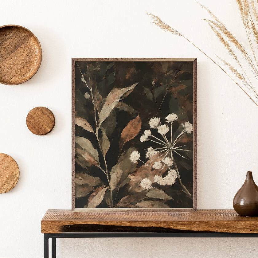 Framed botanical art on a wooden shelf with decorative elements.