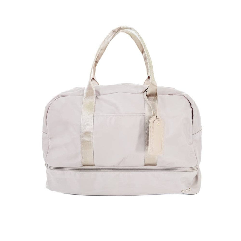 Cream  duffel bag with white handles and trim on a white background