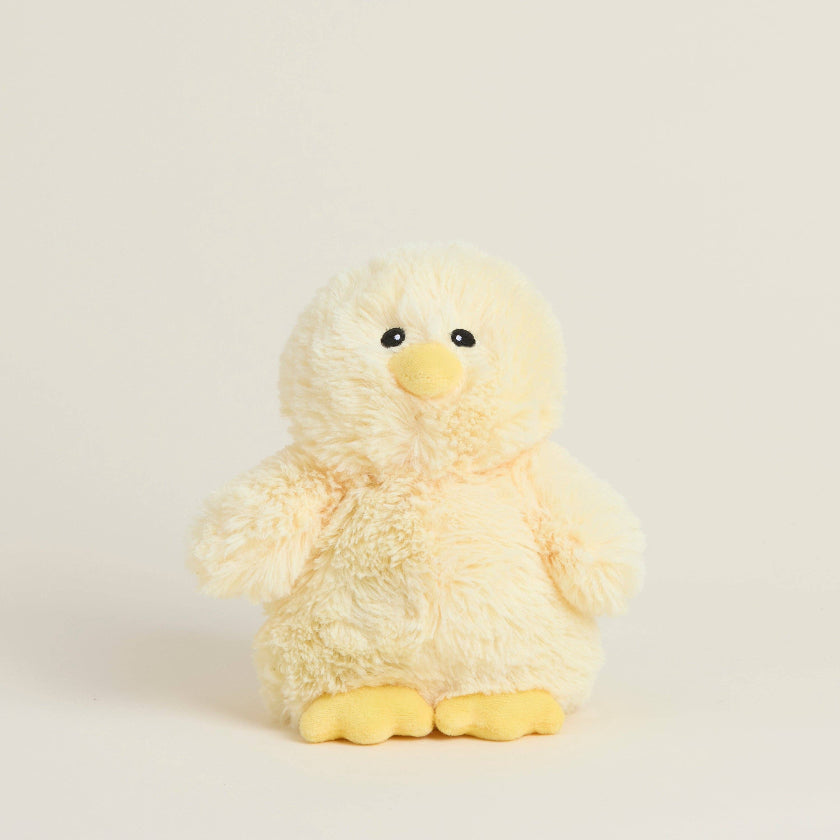 Plush toy chick on a light beige background