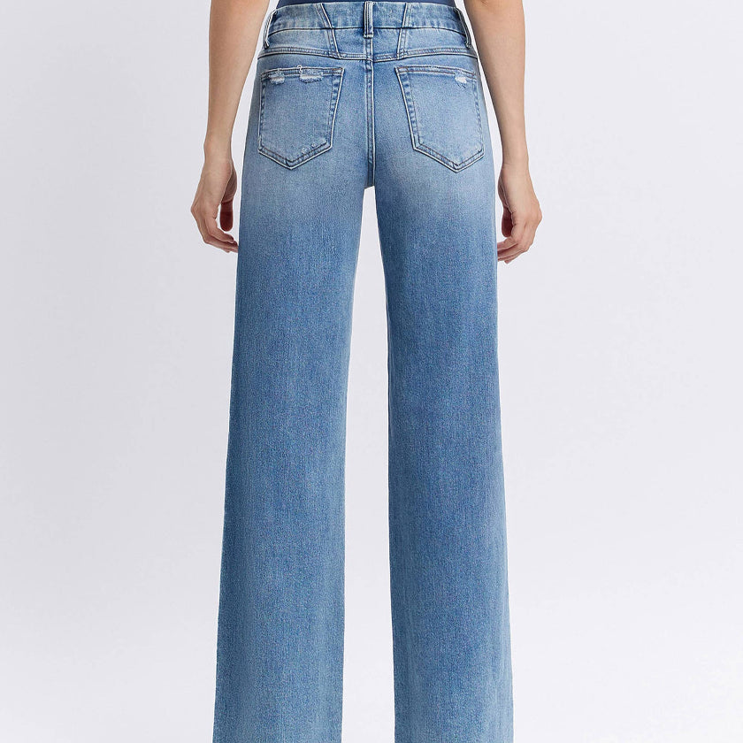 Light blue jeans worn by a person on a white background