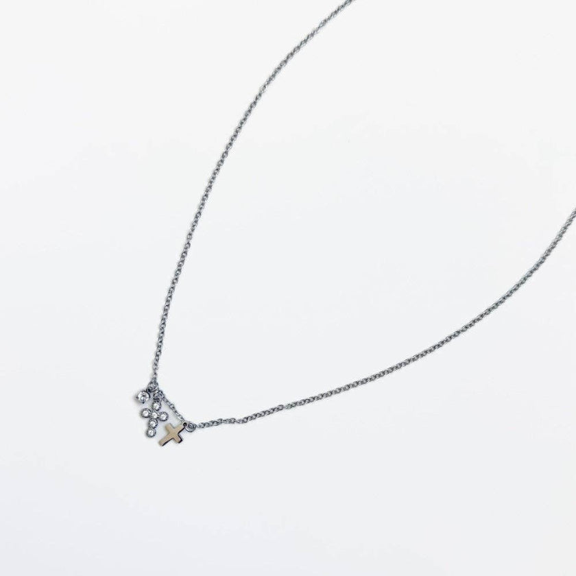 Necklace with a small cross pendant on a white background