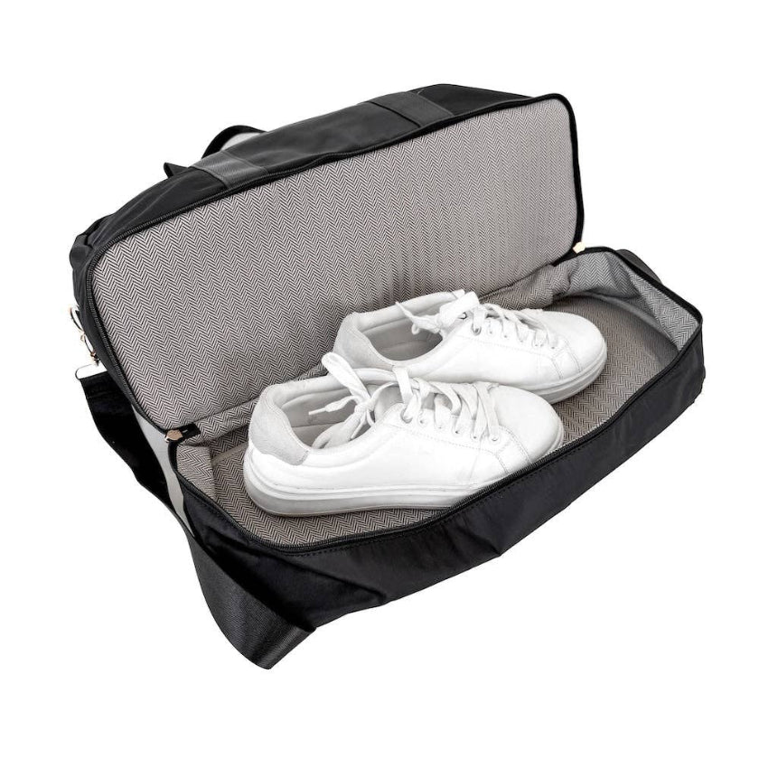 Black shoe bag with white sneakers inside on a white background