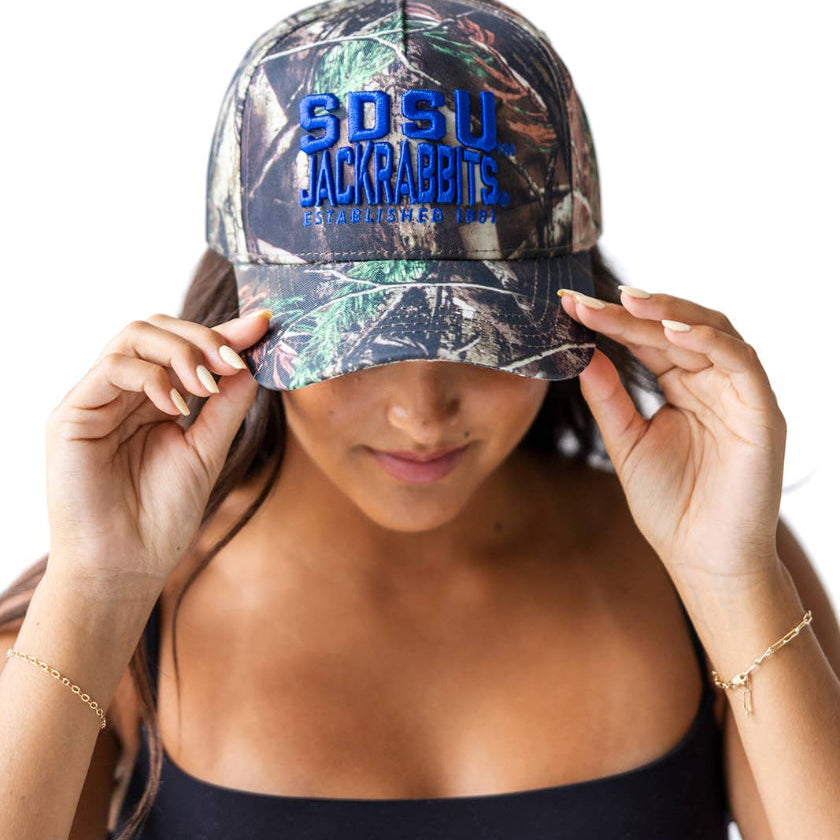 Person wearing a camouflage baseball cap with 'SDSU Jackrabbits' text on a white background
