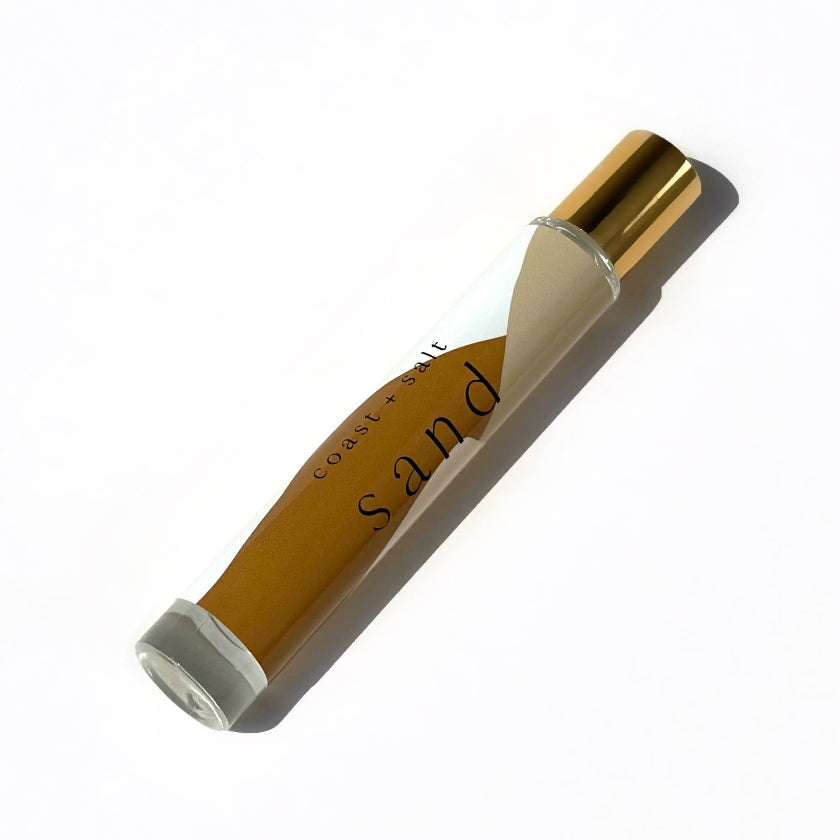 Cosmetic product with gold cap and beige body on a white background
