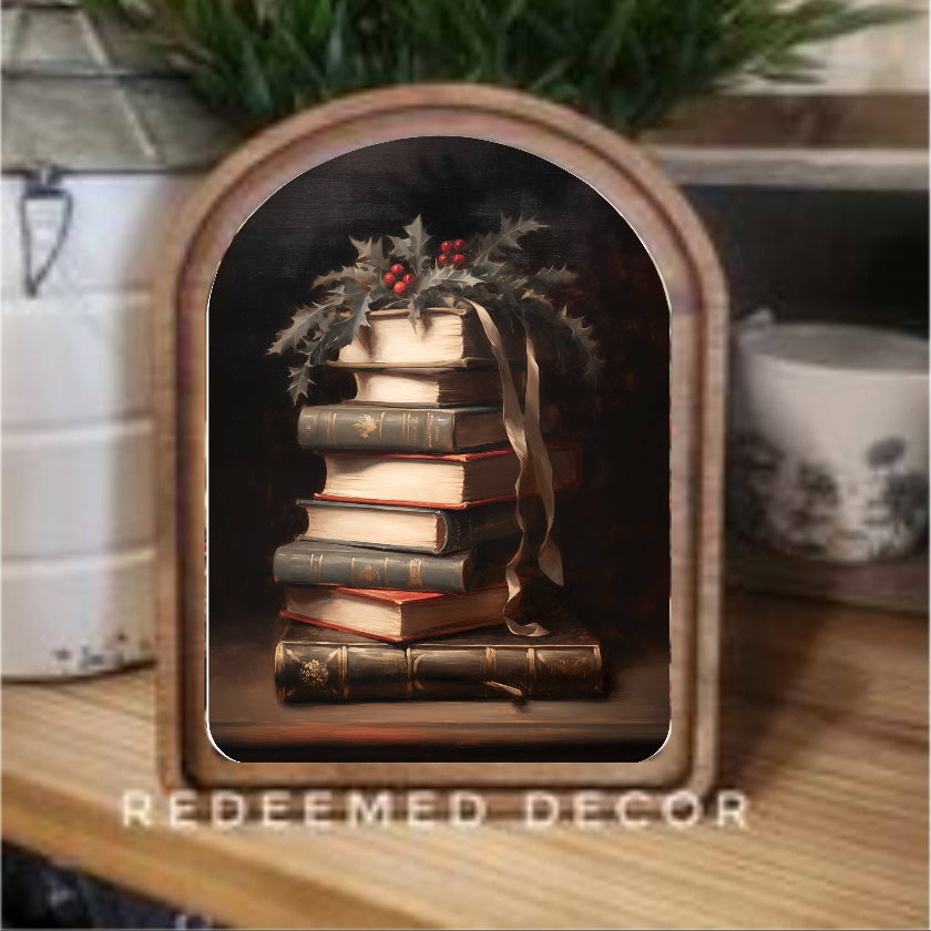 Decorative shelf with books and greenery, featuring the brand 'Redeemed Decor'.