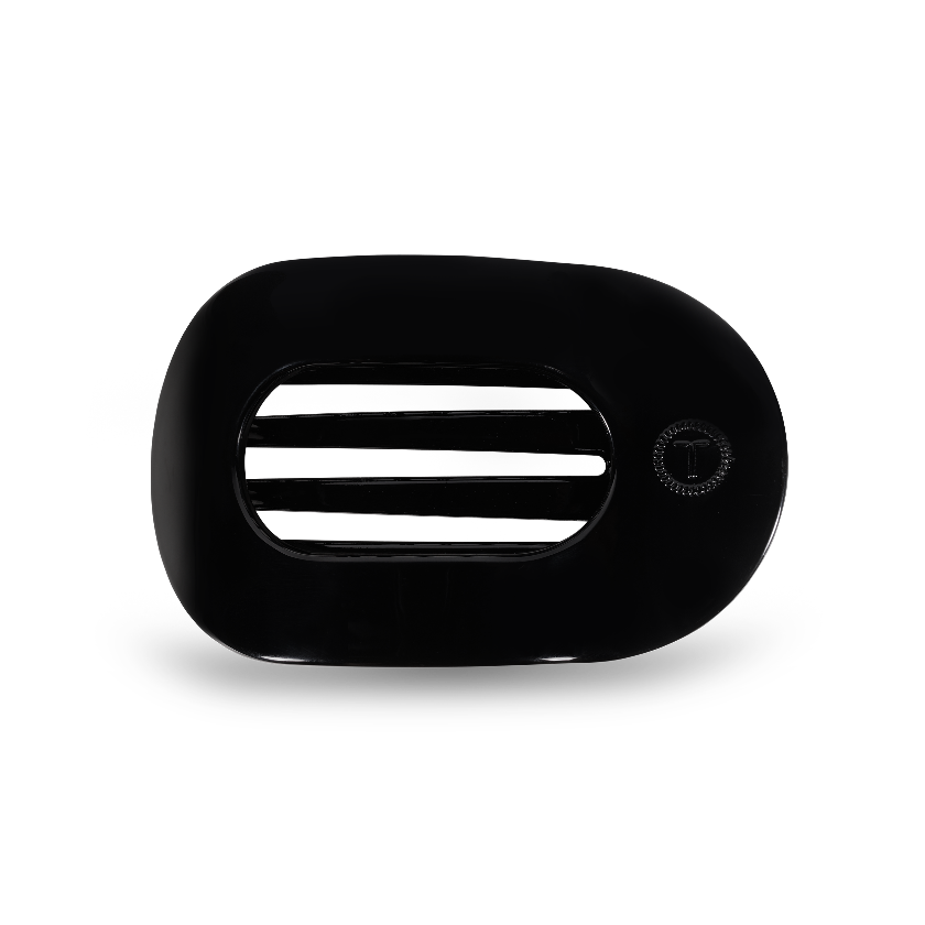 Black rectangular device with a central slit on a white background