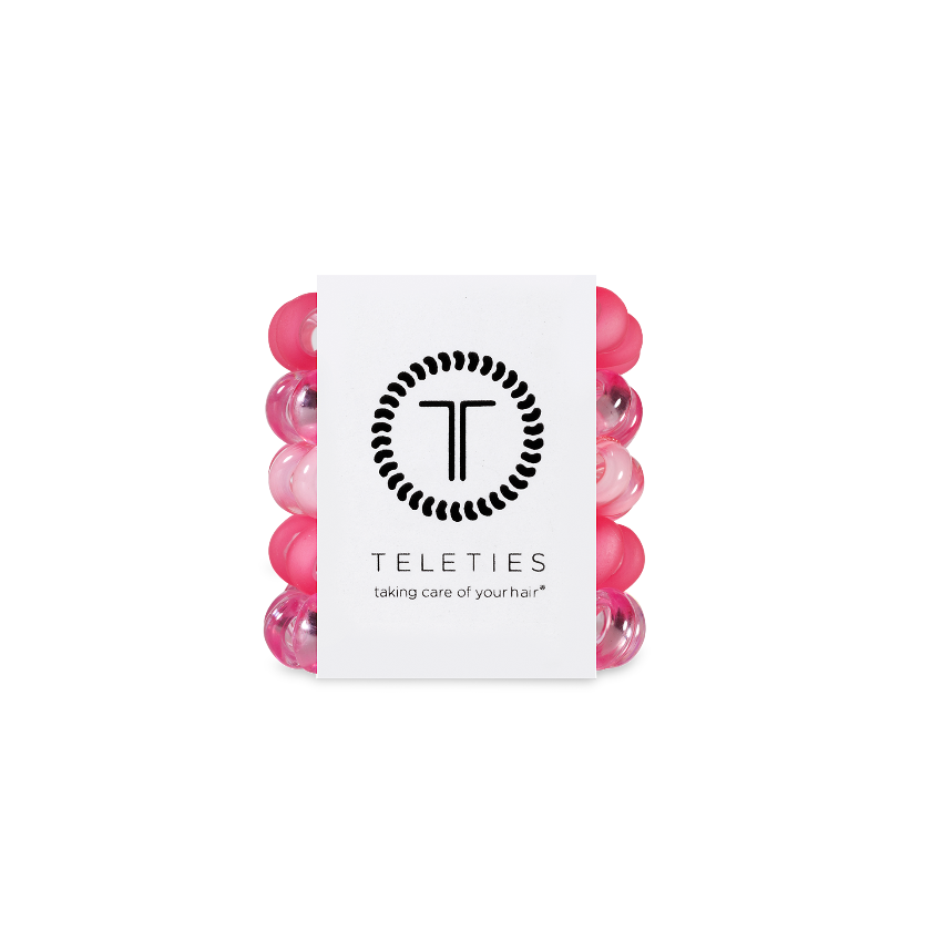 Pink hair ties with a white label featuring the brand 'Teleties' on a white background.