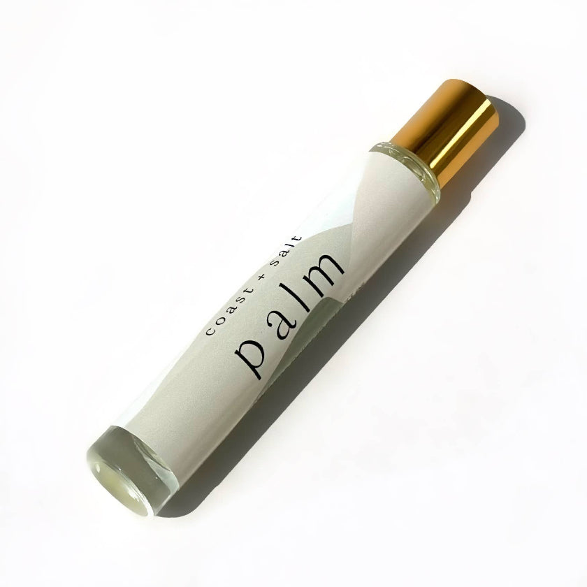 Roll-on bottle with gold cap and white body on a white background
