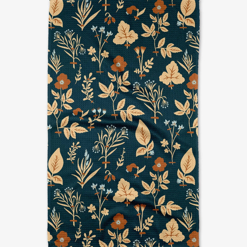 Floral patterned towel with leaves and flowers on a dark blue background