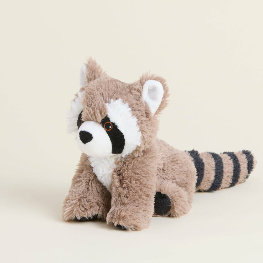 Plush raccoon toy on a beige background