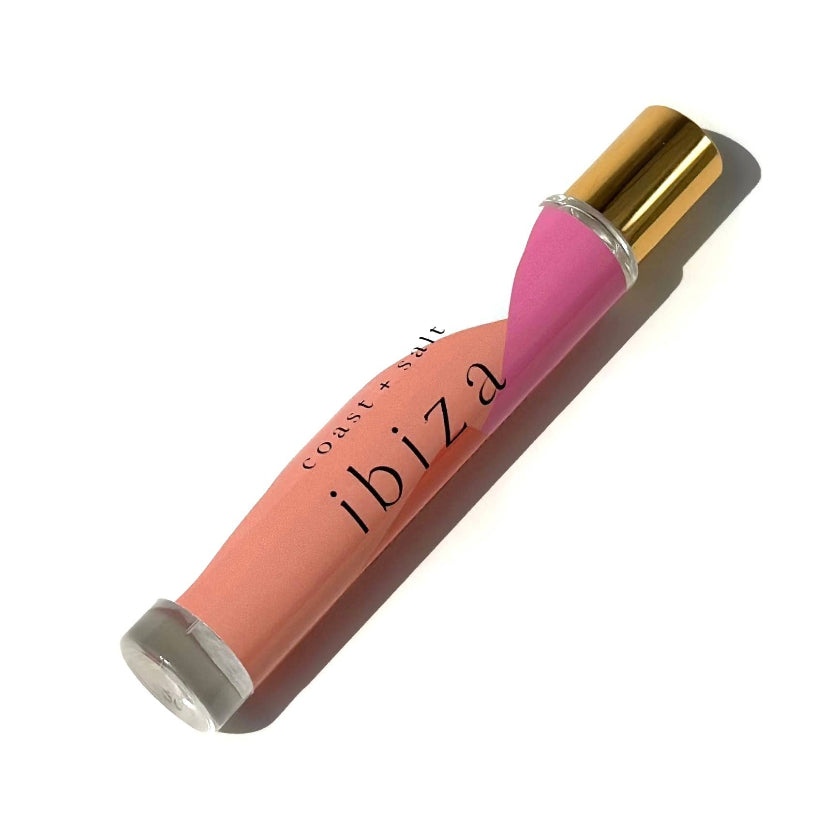 Lip gloss with pink cap and body on a white background