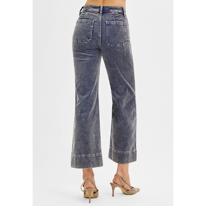 Blue jeans worn by a person on a white background