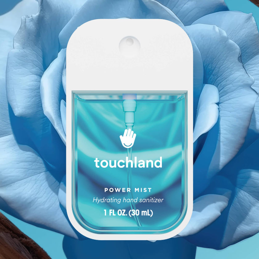 Touchland power mist hand sanitizer with blue floral background