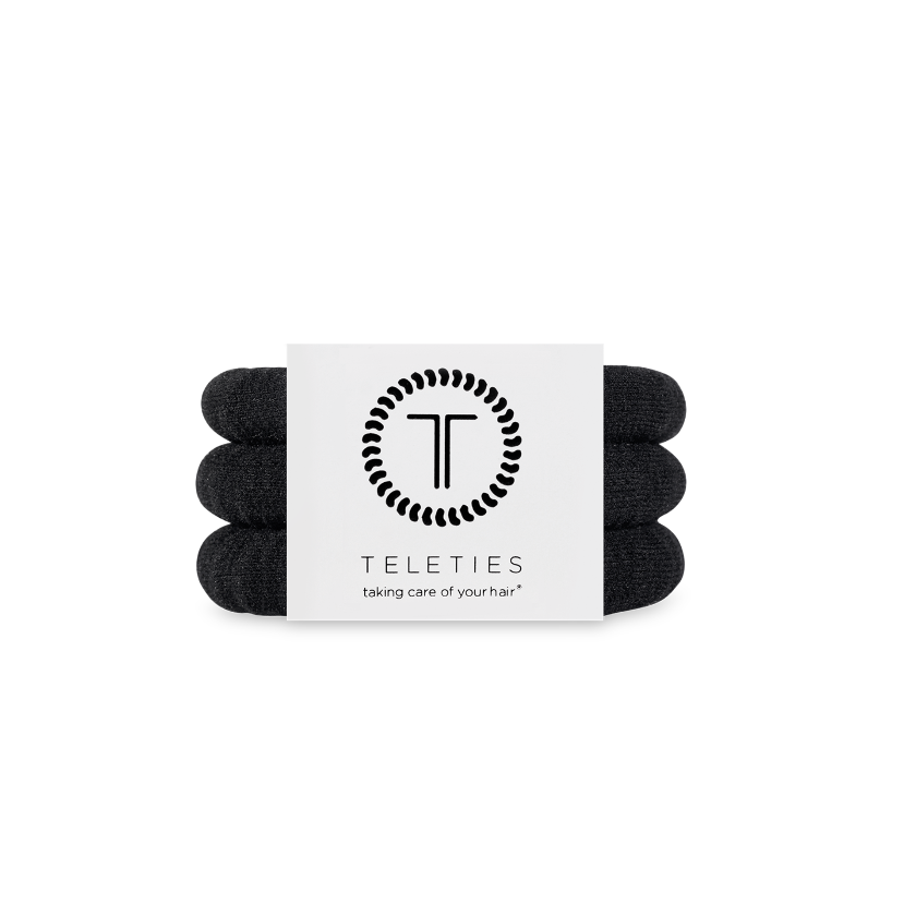 Pack of black hair ties with Teleties brand label on a white background