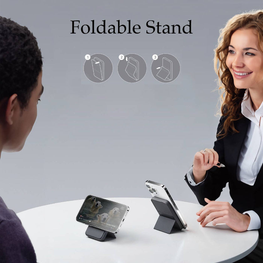Two people using a foldable stand with their smartphones on a gray background