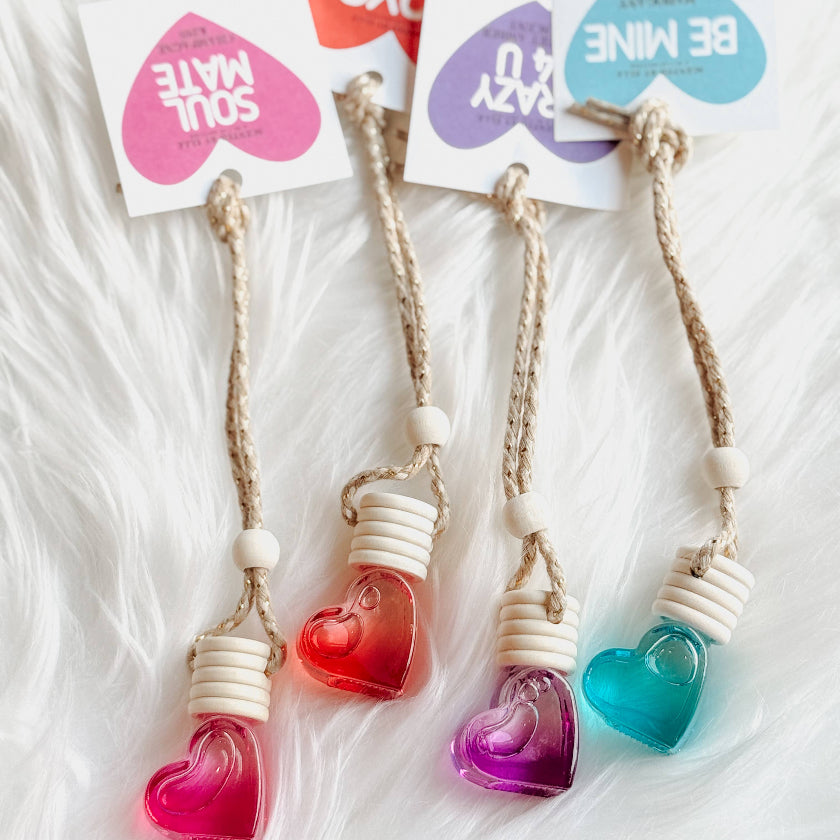 Heart-shaped keychains with colorful beads on a white background