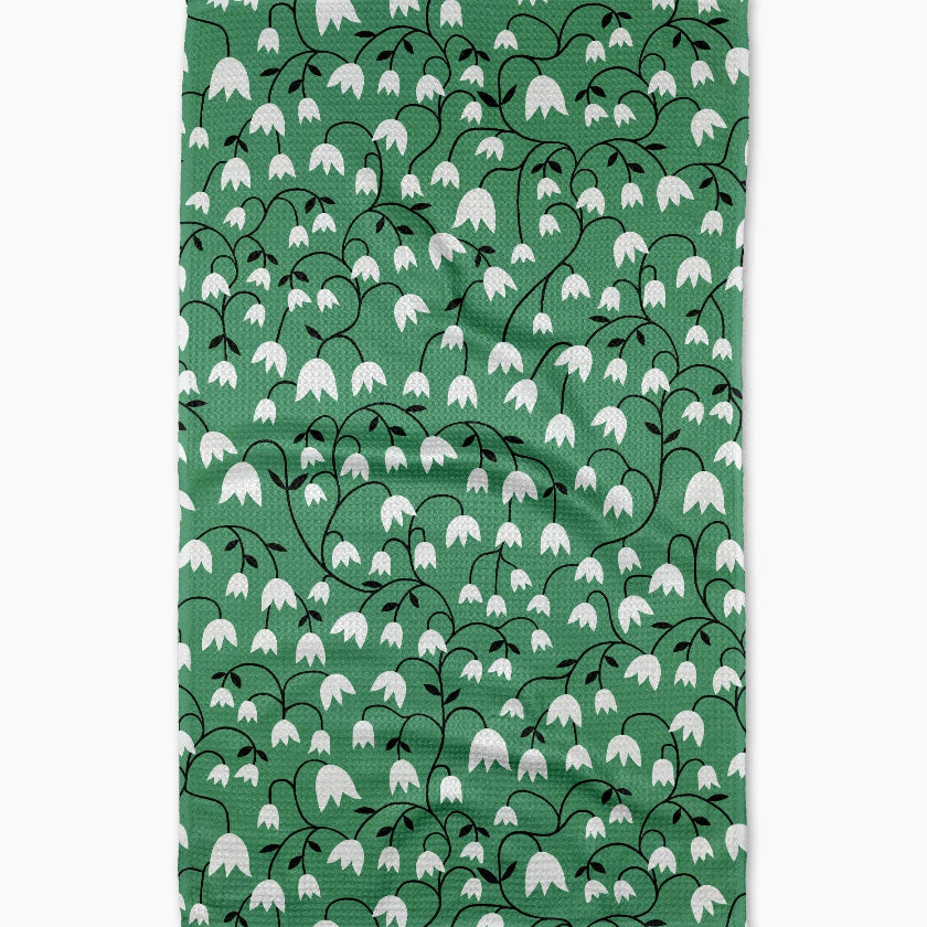 Green fabric with white floral pattern on a white background