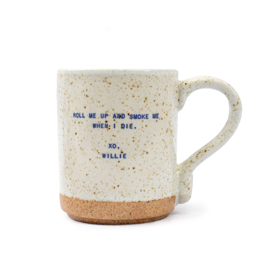 Speckled mug with text 'Roll me up and smoke me when I die. xo, Willie' on a white background