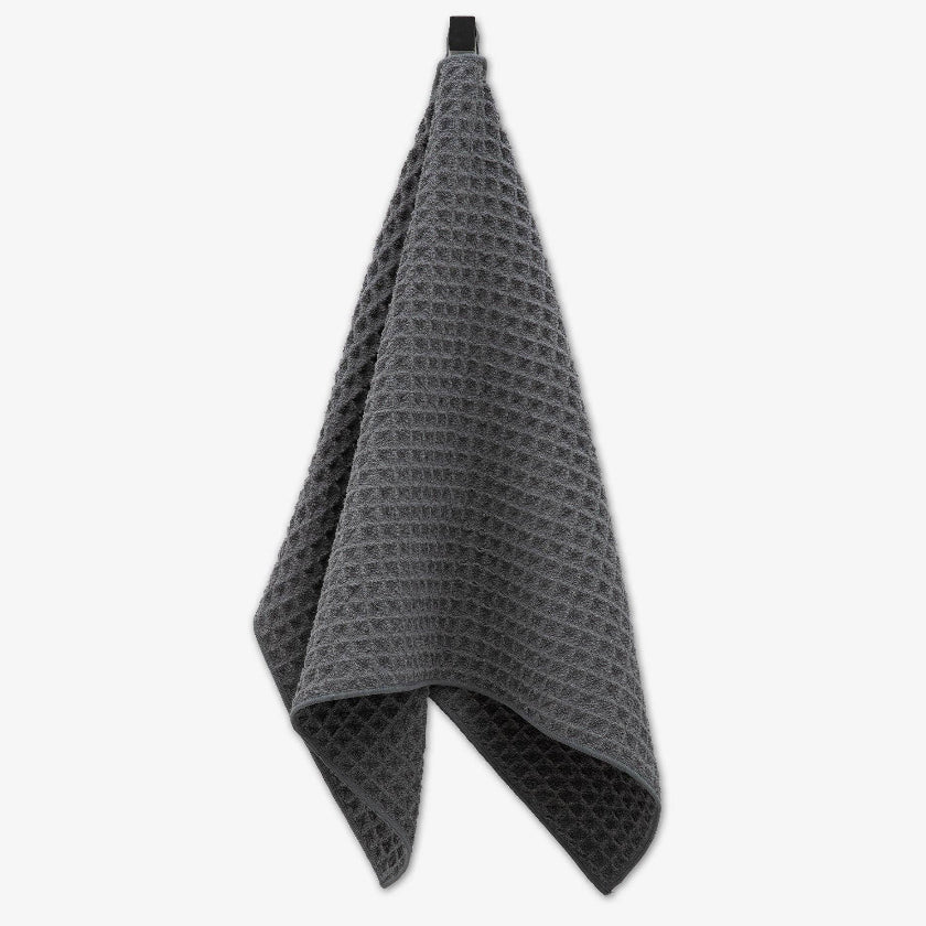 Gray waffle-textured towel on a white background