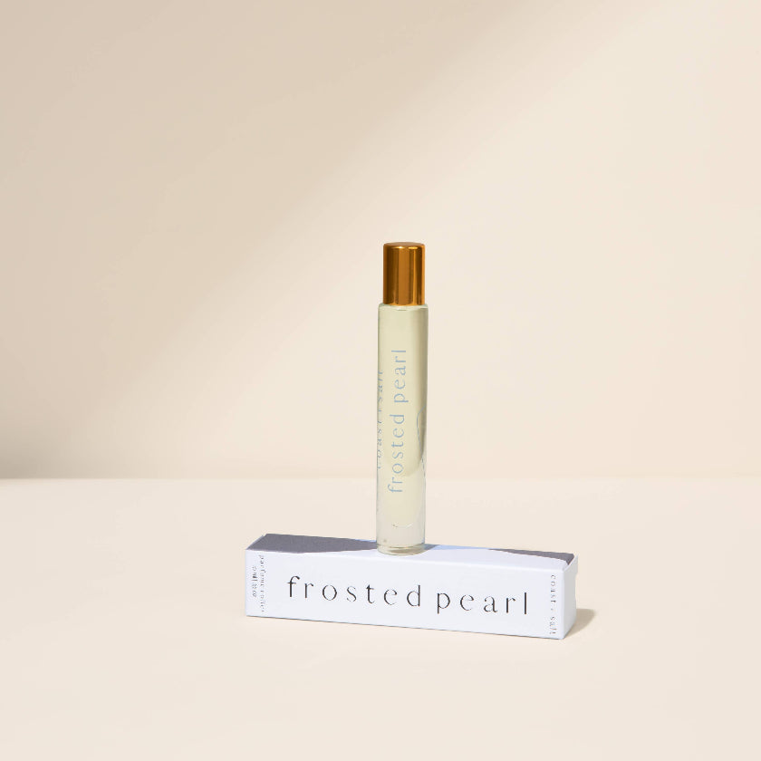 Roll-on bottle labeled 'Frosted Pearl' on a beige background