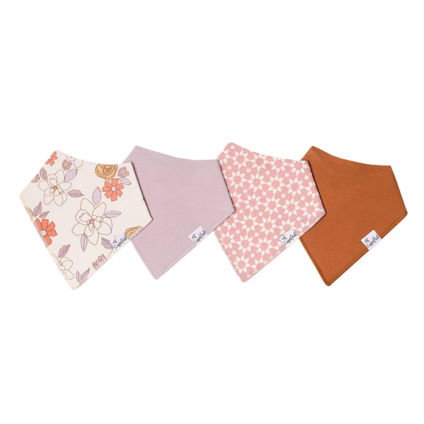 Four colorful baby bibs with floral and polka dot patterns on a white background