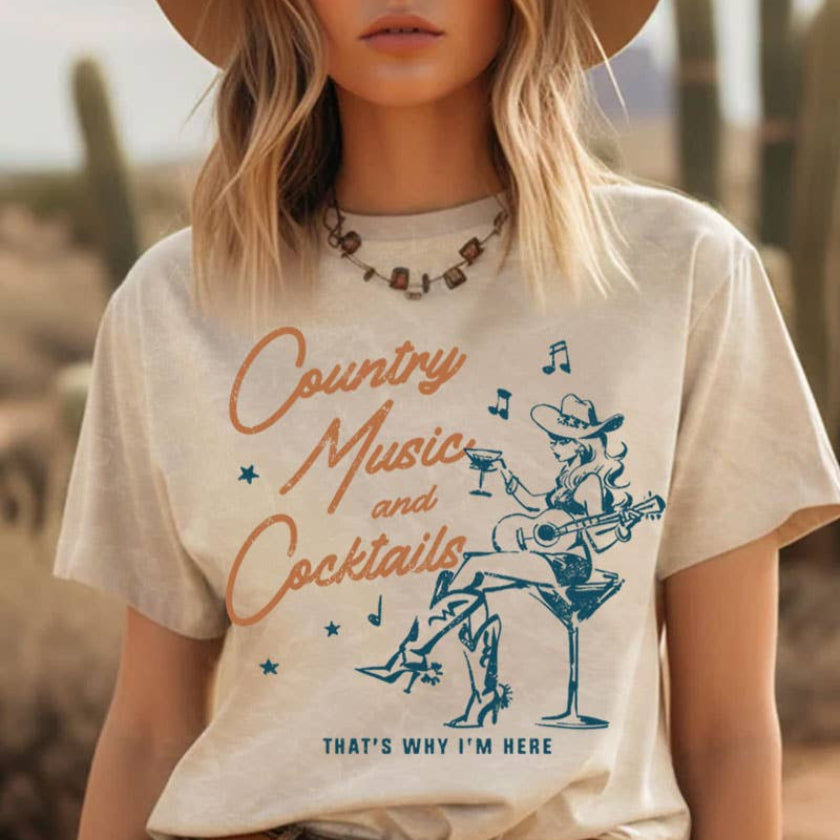 Woman wearing a 'Country Music and Cocktails' t-shirt in a desert setting