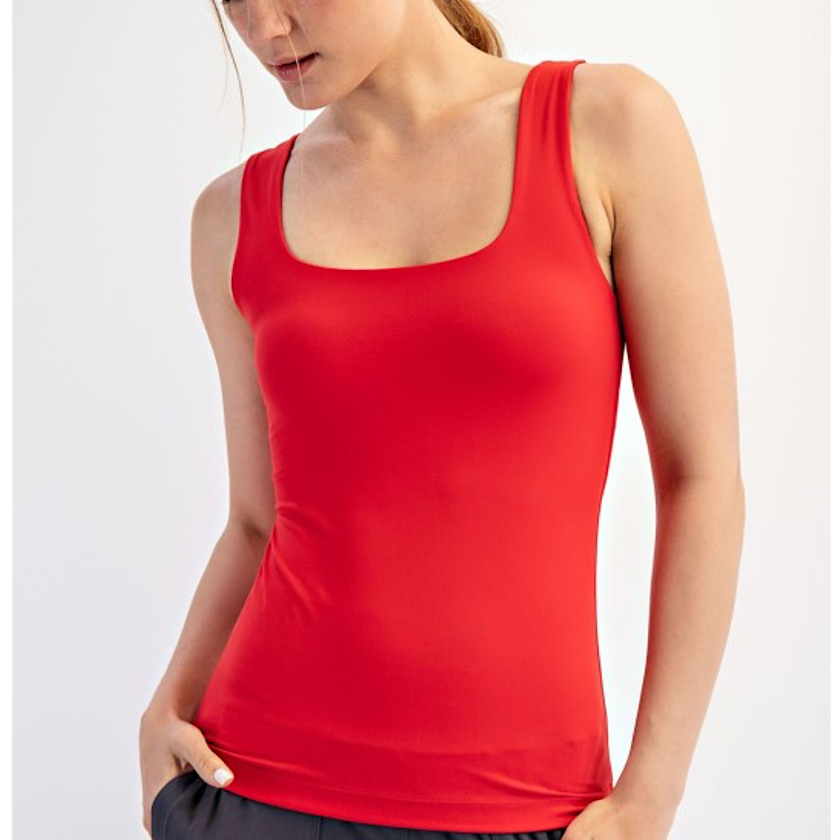 Red tank top worn by a person on a white background