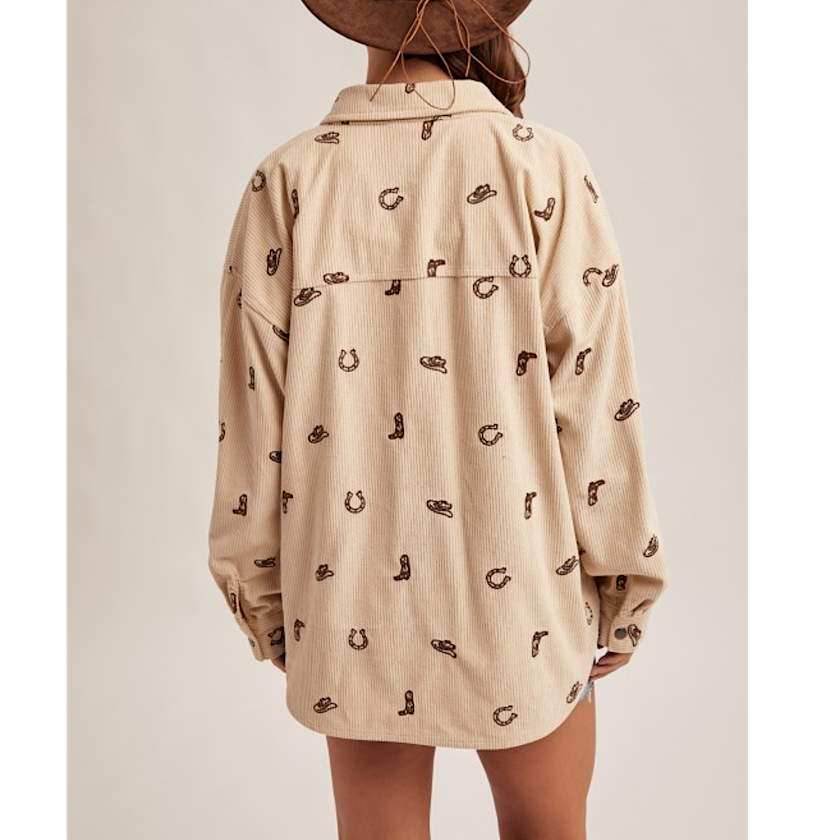 Beige shirt with pattern worn by a person on a plain background