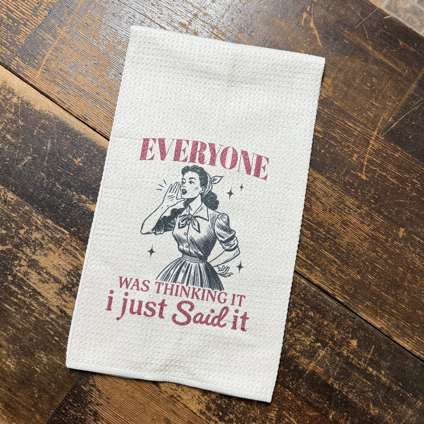 Textile with printed design and text on a wooden surface