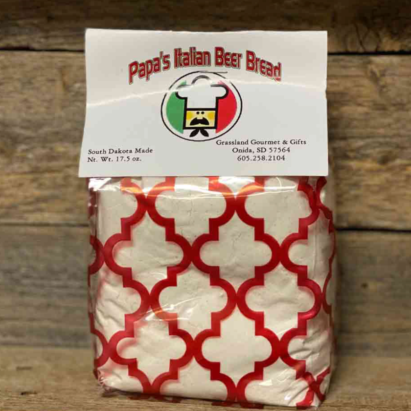 Bag of Papa's Italian Beer Bread with a red and white pattern on a wooden background