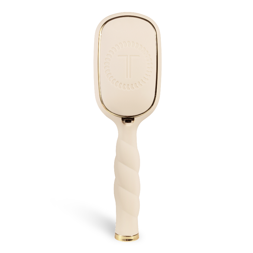 Gold paddle brush on a white background