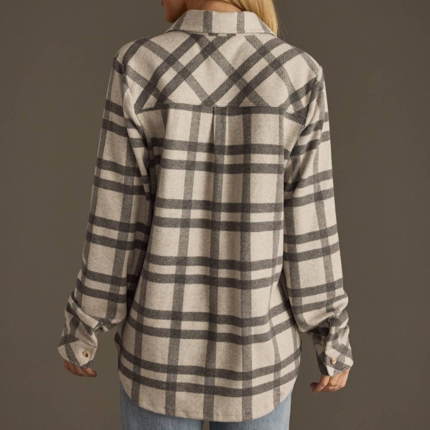 Woman wearing a plaid shirt with a brown background