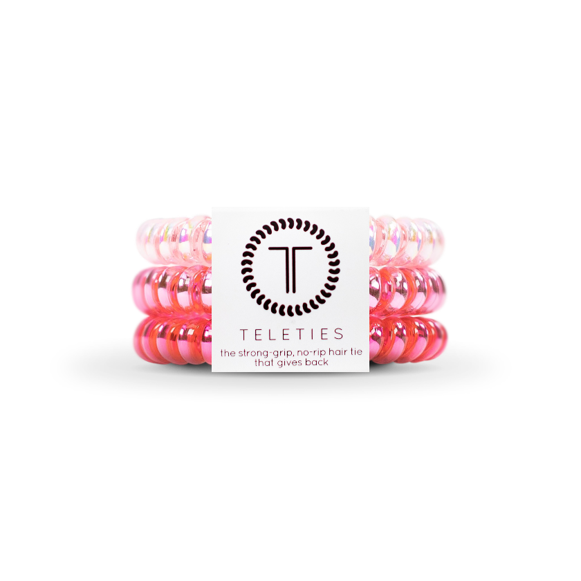 Pack of pink hair ties with a Teleties branded card on a white background