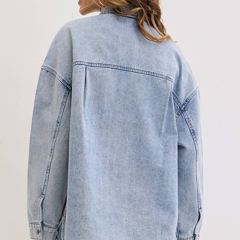 Light blue denim jacket worn by a person on a white background