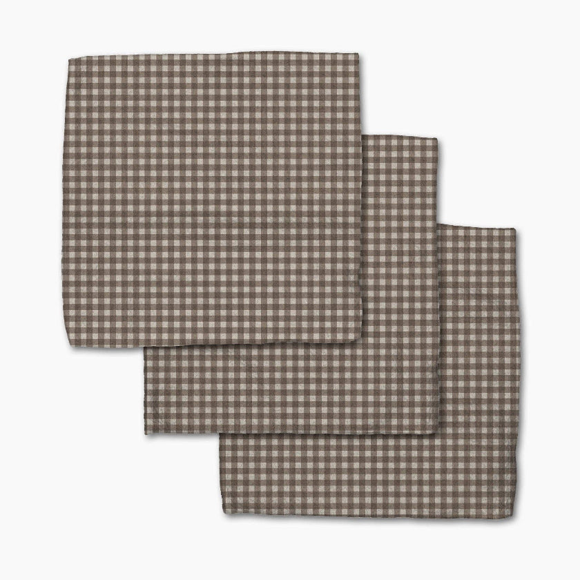 Set of three brown checkered placemats on a white background