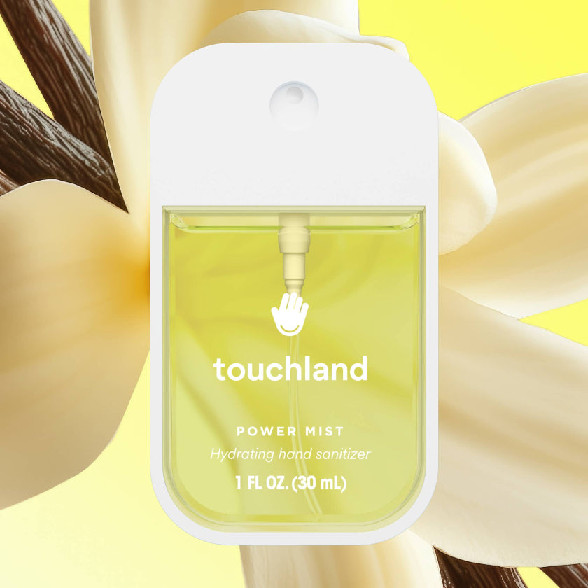 Touchland power mist hand sanitizer bottle with a floral background