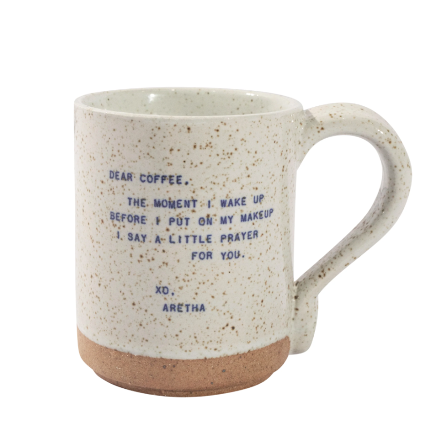Speckled mug with blue text on a white background