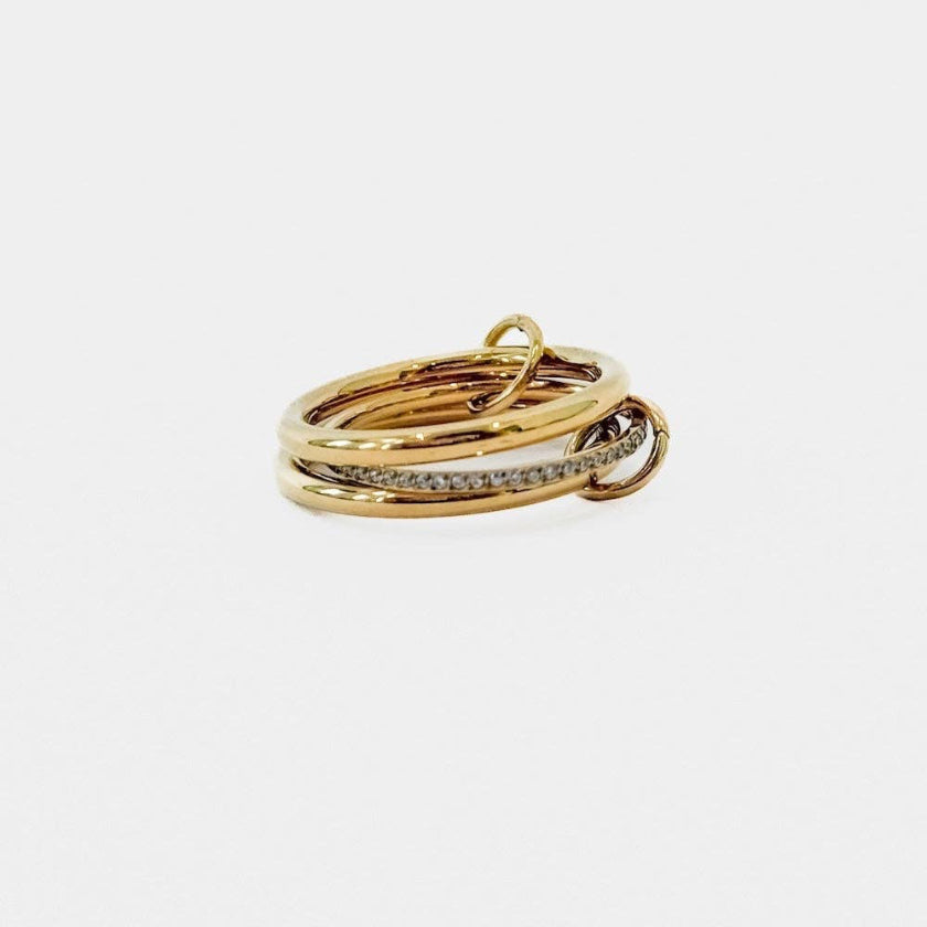 Three gold rings stacked on a white background