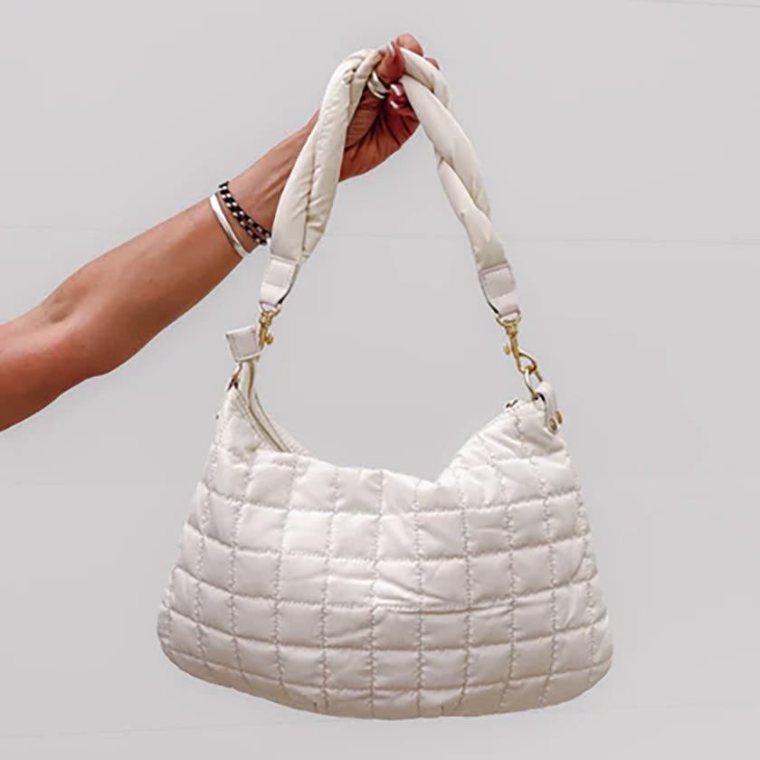 Our Bentley Braided Handbag in Cream is the perfect puffer winter purse and an absolute showstopper! This lightweight bag is a fun and unique way to style your outfit. 