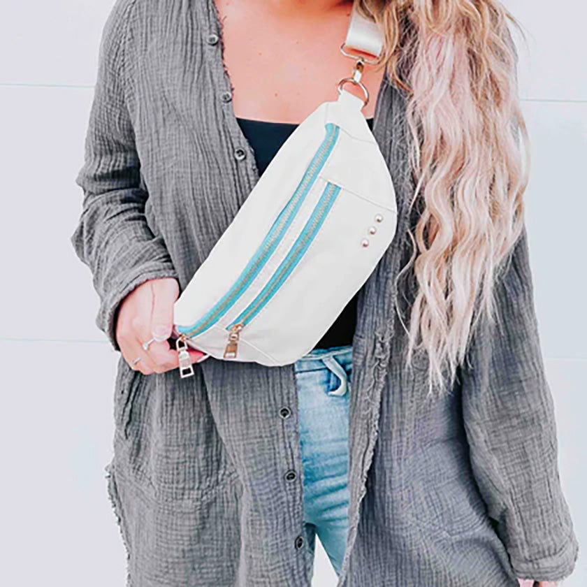 The Blakely Bum Bag in Cream is a nylon bag that has an adjustable and removable strap, and can be worn either across your body or around your waist. It has two exterior zipper pockets, one to hold your smaller items and the other to hold your larger items. 