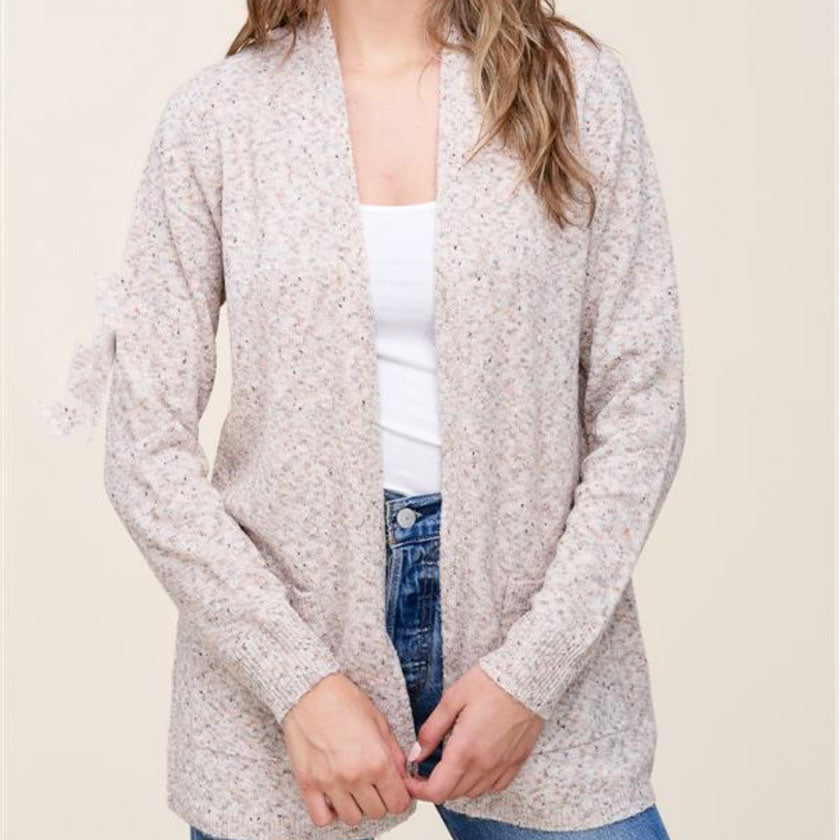 Oatmeal cardigan sweater. Open front, long sleeve, pockets, lightly sprinkled.