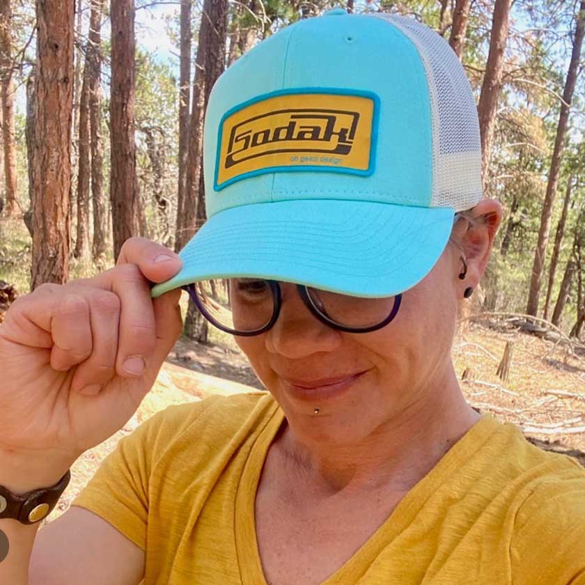 This new SoDak Classic flatbill hat, in teal, is inspired by old school car hood ornaments! Show your love for South Dakota with one of these fun retro snapback flat bill hats.