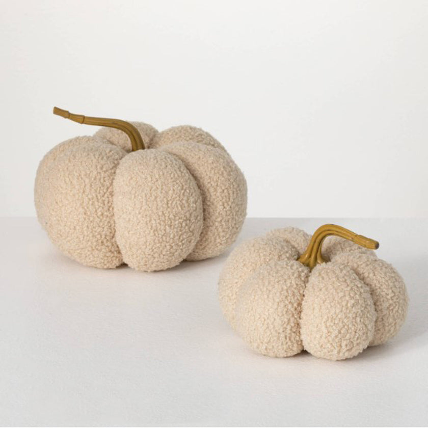 Small, cream colored pumpkin covered in textured boucle fabric, this decorative pumpkin will look splendid on display from early autumn all the way through Thanksgiving.